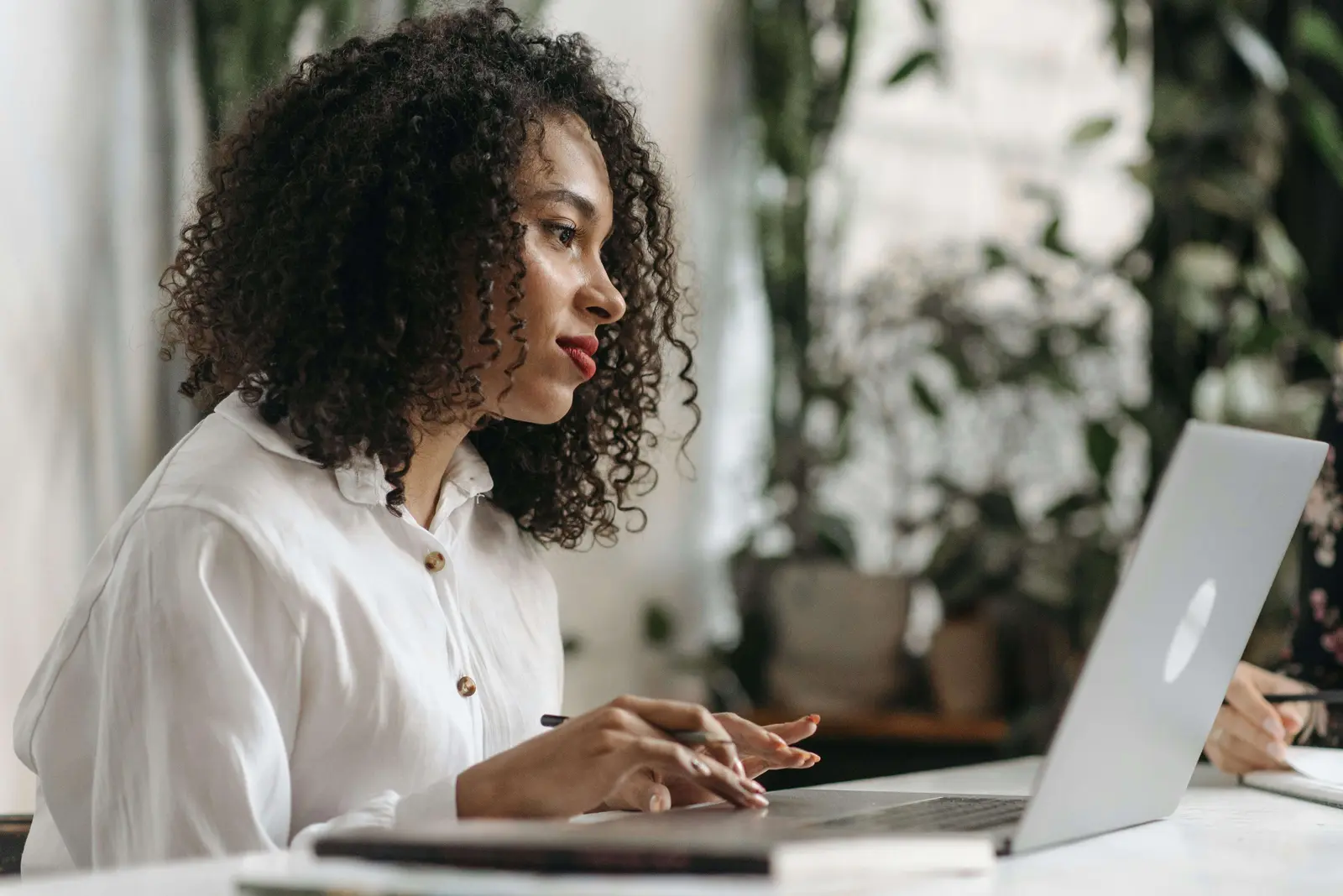 Working professional taking her online class on a laptop at home: Academikx pays after results online class help